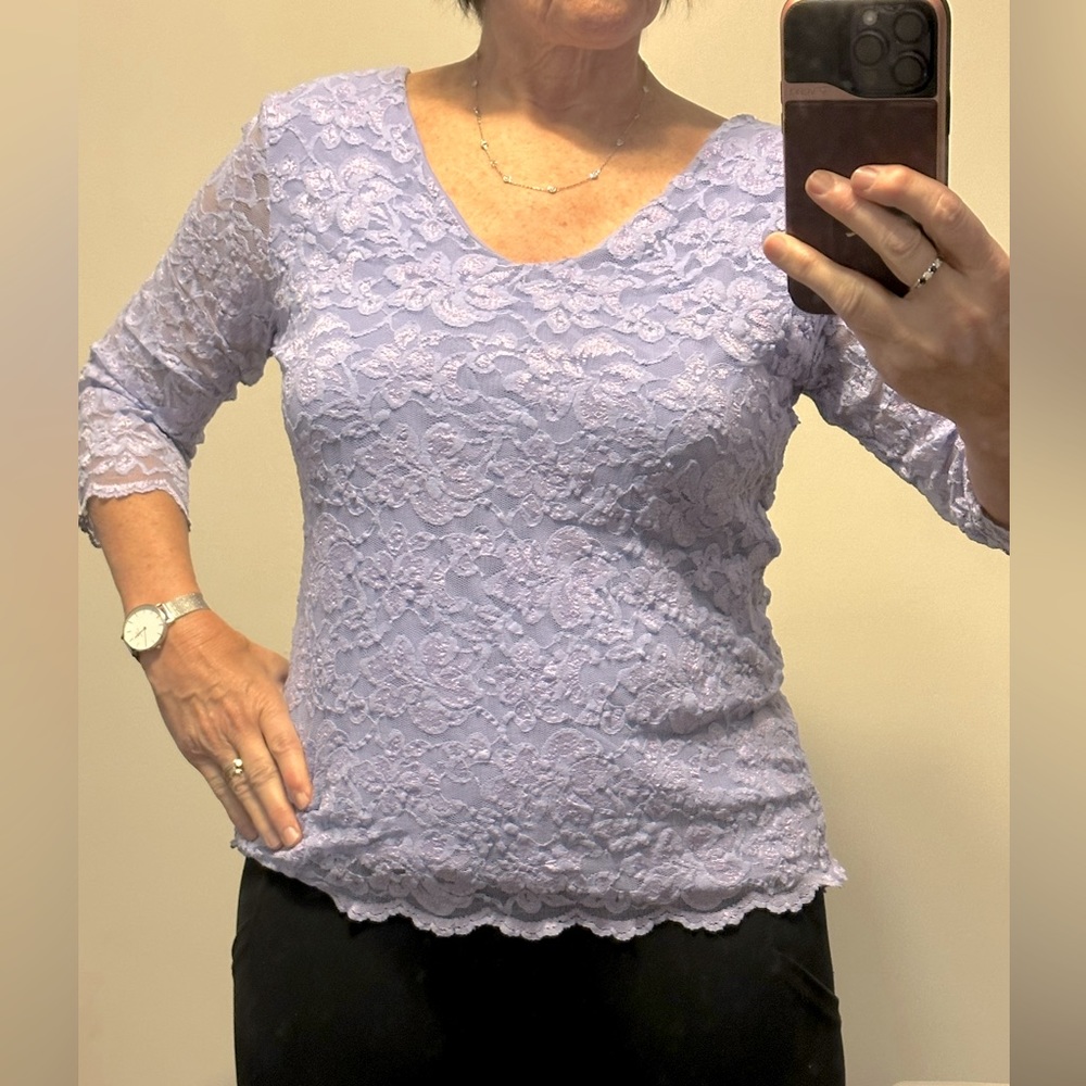 Feminine lace overlay with 3/4 sleeve.